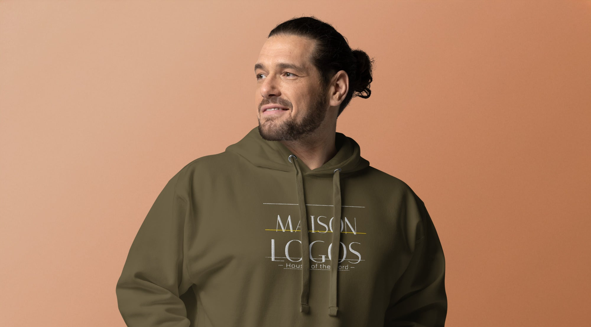 Man wearing a green hoodie with 'Maison Logos' text on a brown background